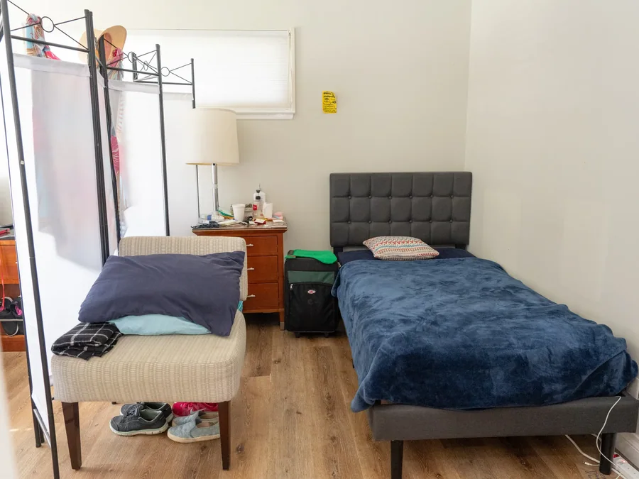 Comfortable shared resident bedroom with two beds and natural light